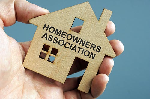 hand holding house homeowners association concept