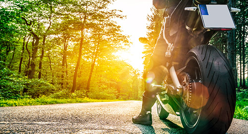 motorcycle rider taking a break while riding into sunset