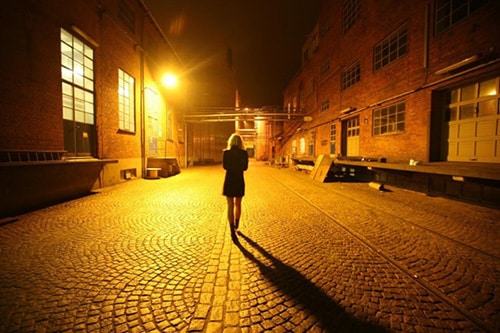 woman walking home alone at night in the city